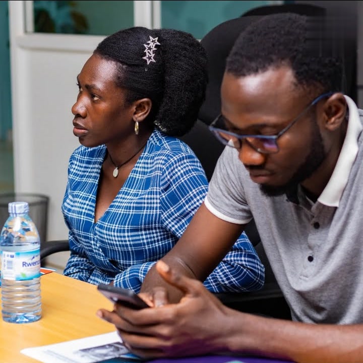 Charles Oriokot and another participant listening during an intellectual-property and innovation session
