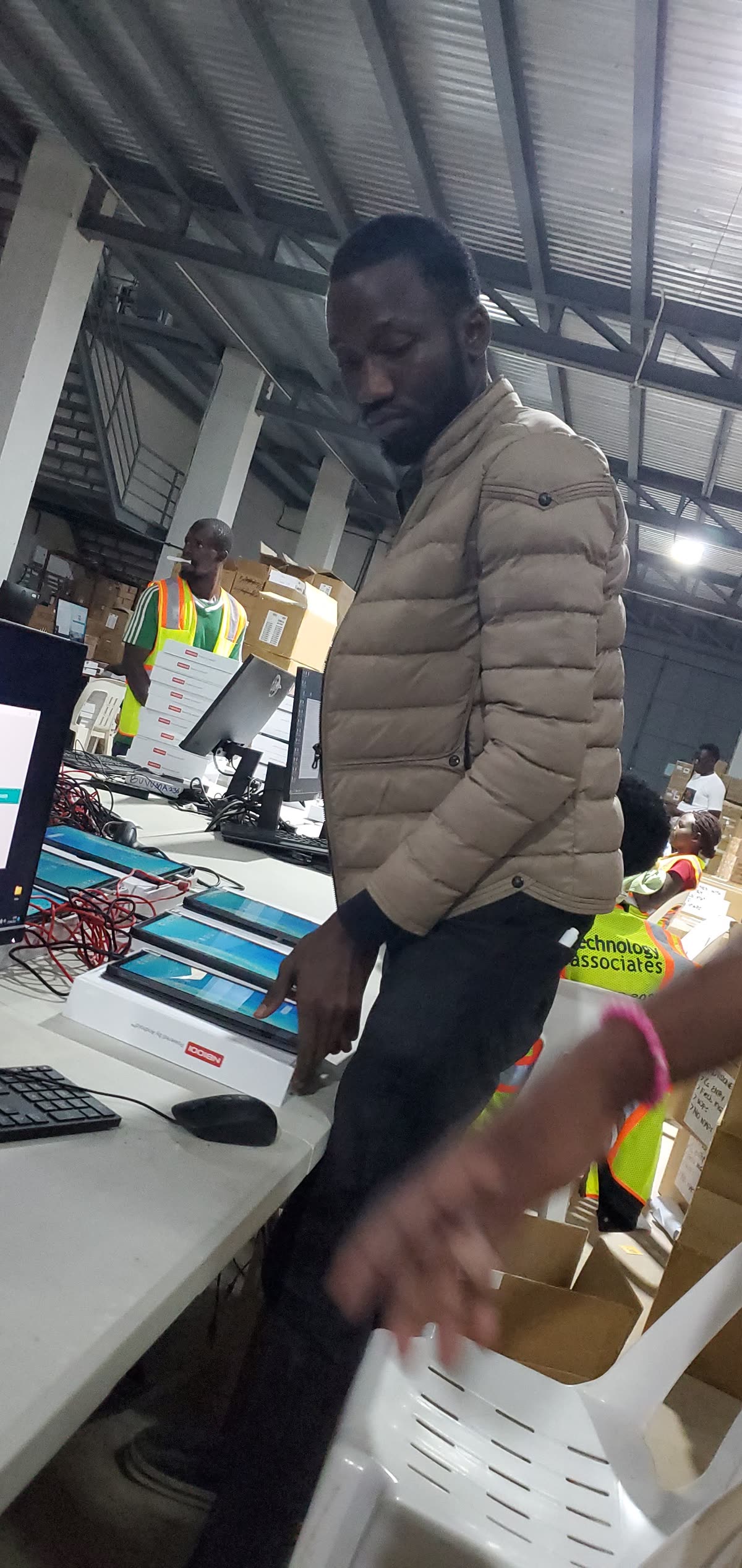 Charles Oriokot checking a tablet during Digital Census device preparation