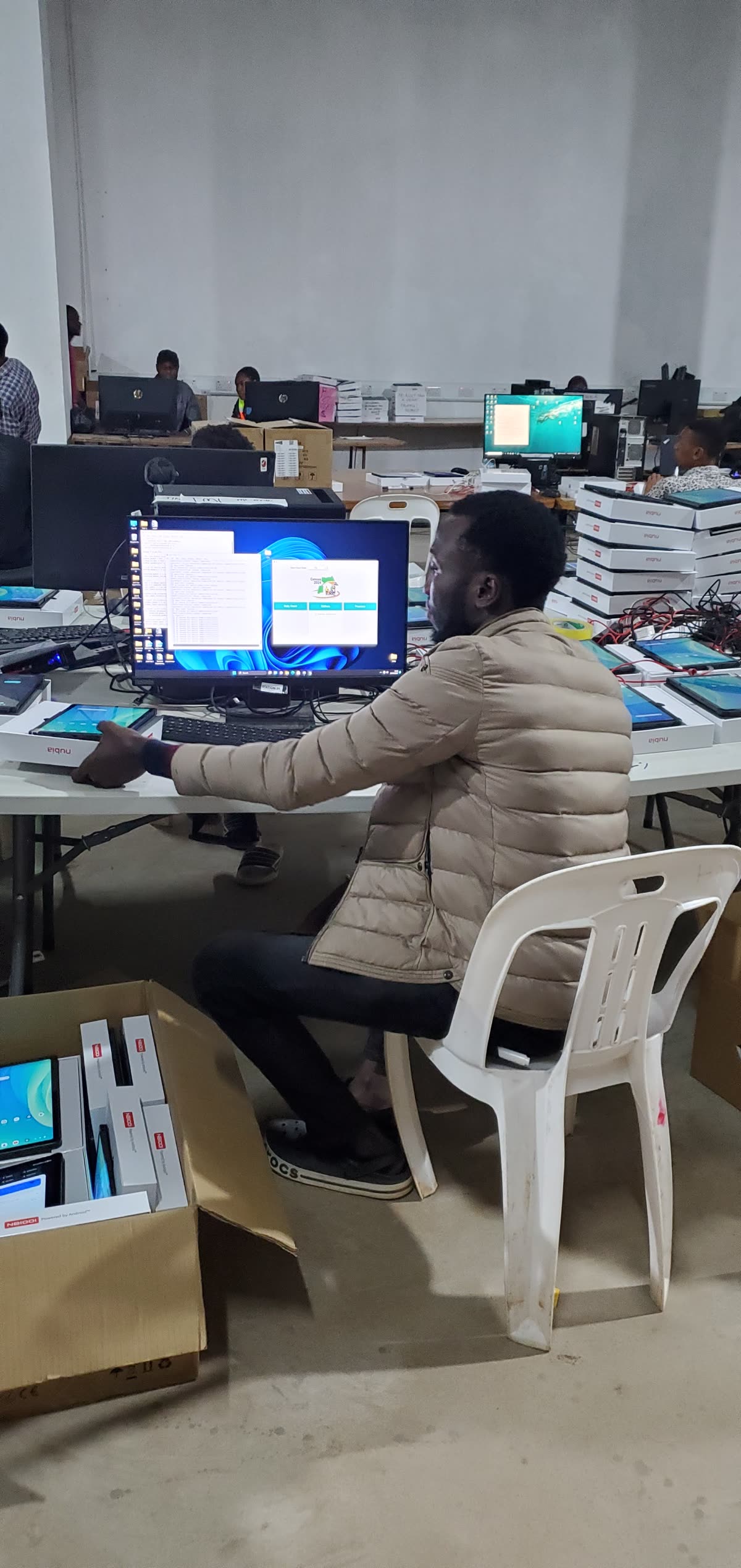 Charles Oriokot operating the Census application during tablet readiness work