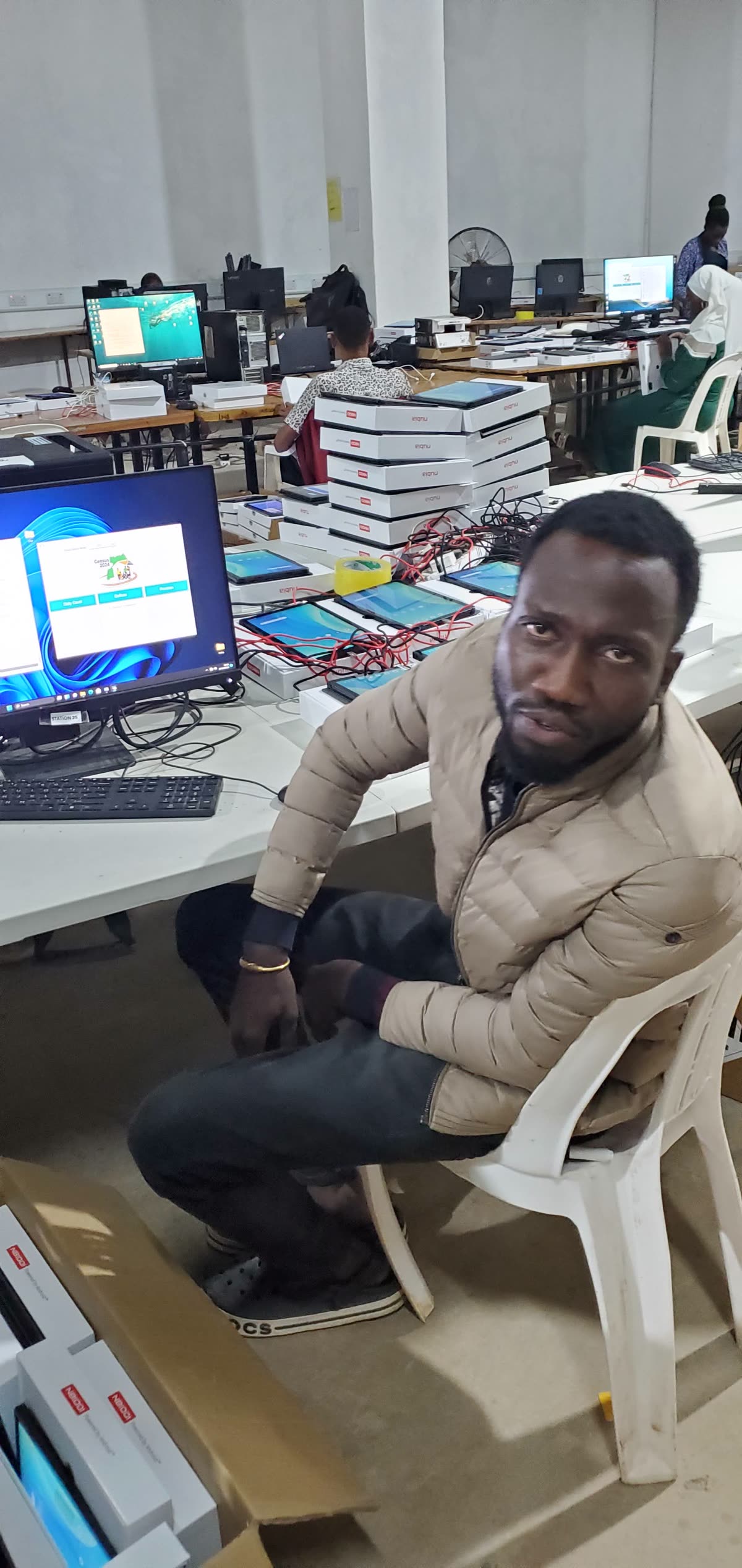 Charles Oriokot reviewing a tablet during a Digital Census deployment preparation session